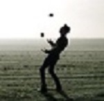 man juggling in field.